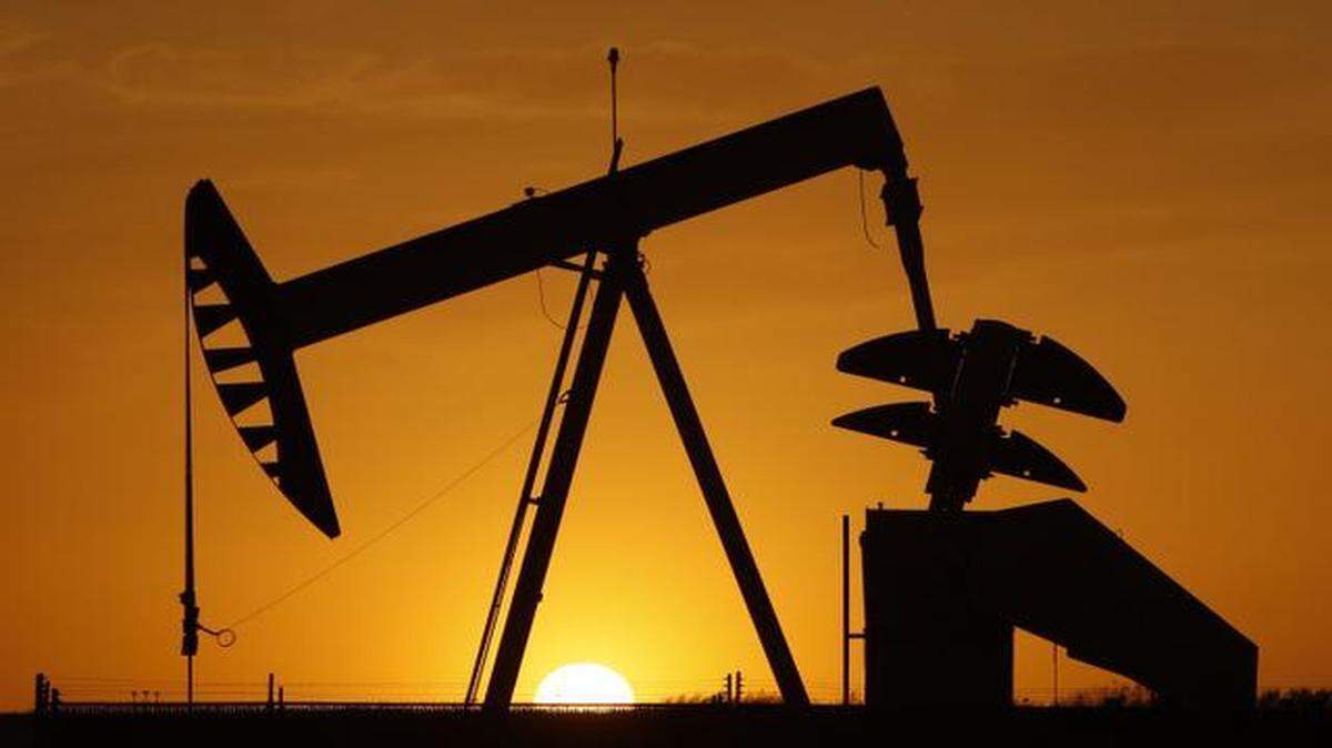 
An oil pump jack is silhouetted against the setting sun in Oklahoma City.
