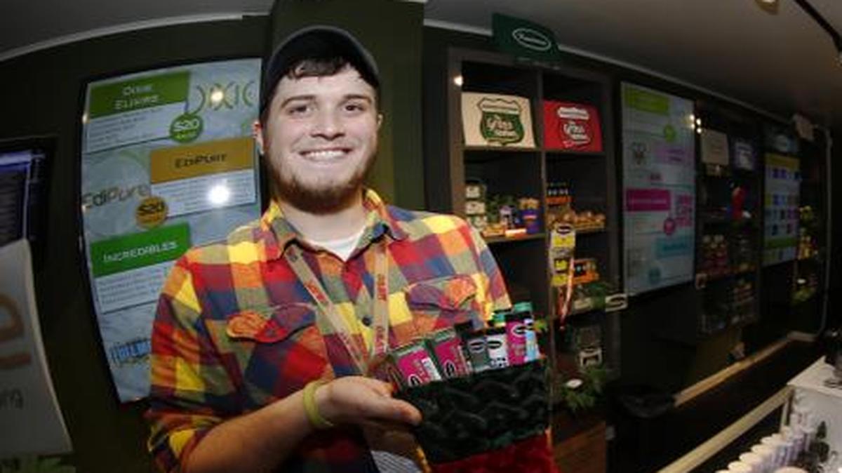 
Bud tender Maxwell Bradford shows off holiday stocking filled with more than $500 of marijuana and accessories for sale for the holiday season in a marijuana shop in northwest Denver
