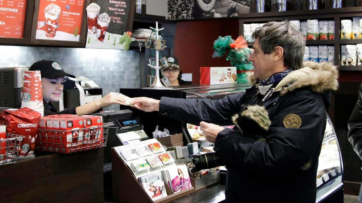 
A customer pays for coffee at Starbucks in New York
