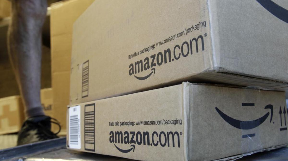 In this June 30, 2011 file photo, a United Parcel Service driver delivers packages from Amazon.com in Palo Alto, Calif. Amazon is offering deals July 12, 2016, for the second edition of its annual "Prime Day" promotion.