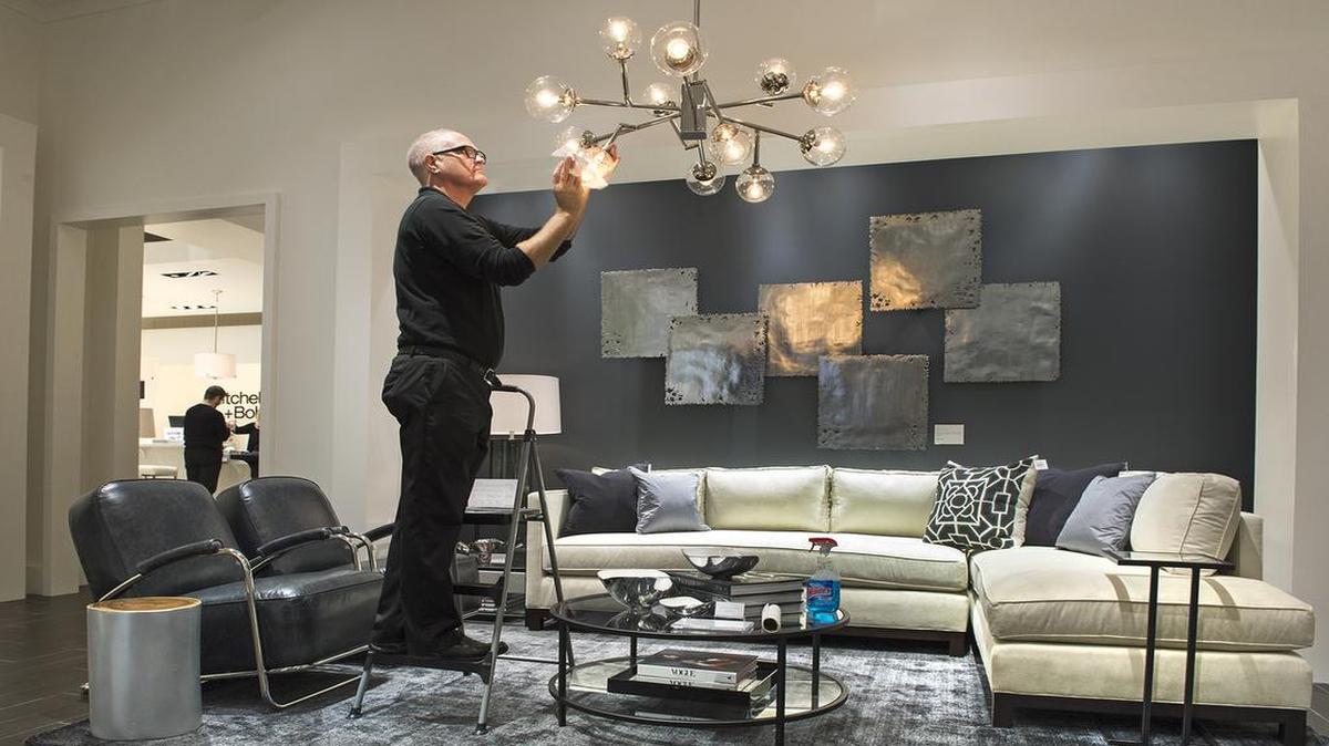 
Design associate Michael Kathrens cleaned a lighting fixture in preparation for the opening of the Mitchell Gold + Bob Williams store at 4563 W. 119th St. in Leawood’s Town Center Crossing. The upscale home furnishings store opens Wednesday.
