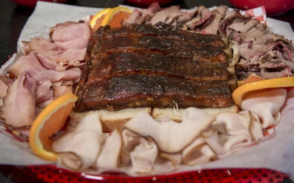 A combination platter at P. Moore & Moore BBQ comes with a choice of one of three sides: creamy corn, baked beans or potato salad.