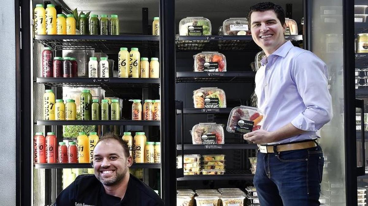 Partners Caleb (left) and Jason Fechter have opened an Evolve Juicery & Paleo Kitchen at 322 Southwest Blvd. Their shop sells bottled juices and packaged meals, displayed in the cooler.