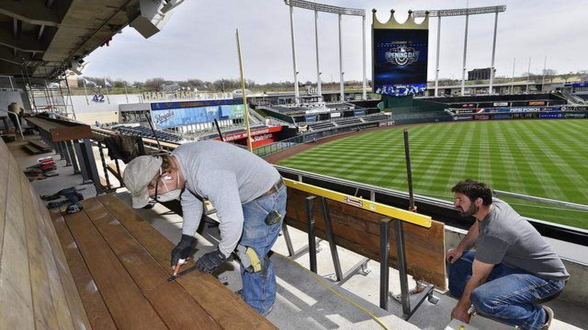 
Preparations were underway Sunday at Kauffman Stadium for Monday’s home opener between the Royals and the White Sox. Derek Elod (left) and Lee Ross installed wooden benches below the new Craft & Draft taproom and build-your-own pizza bar.
