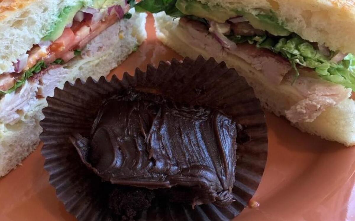 Kneaders’ “Famous Turkey Avocado Sandwich” with slow-roasted hand-pulled turkey, bacon, Kneaders sauce, provolone cheese, lettuce, tomatoes, red onions and avocado served on focaccia for $8.69 and a double fudge brownie for $1.99.