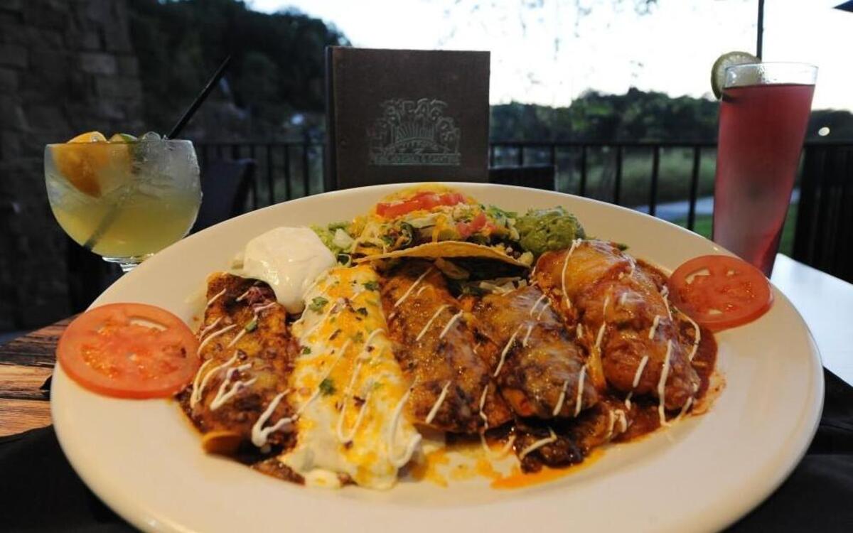 The Cabo Wabo platter at Los Cabos serves two and features a chicken tamale, chili relleno, fajita chicken enchilada, beef enchilada, cheese and onion enchilada, a crispy beef taco and sides. Drink options include the Cabo Bueno Especial (left) and the Top-Shelf Royal Swirl.