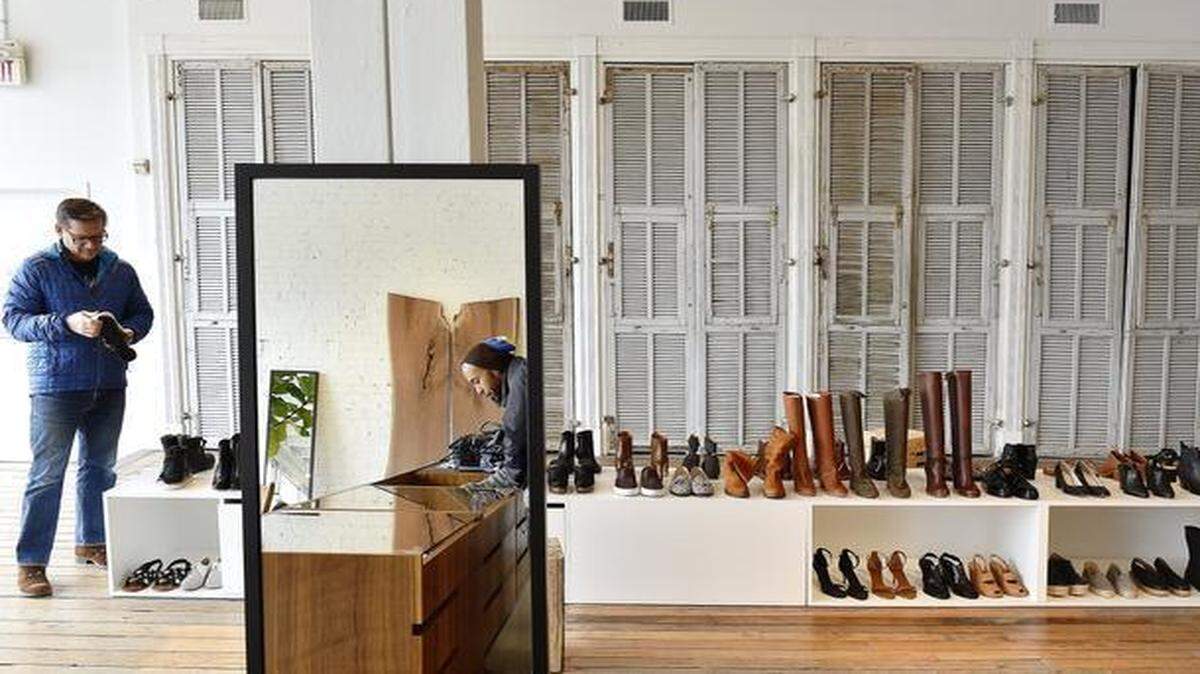 
Finefolk Shop + Studio, which carries contemporary women’s apparel and shoes by designers not previously found in Kansas City, has moved to 122 Southwest Blvd. Patrick Smith (left) and Kenny Johnson (reflected) browsed the store last week.

