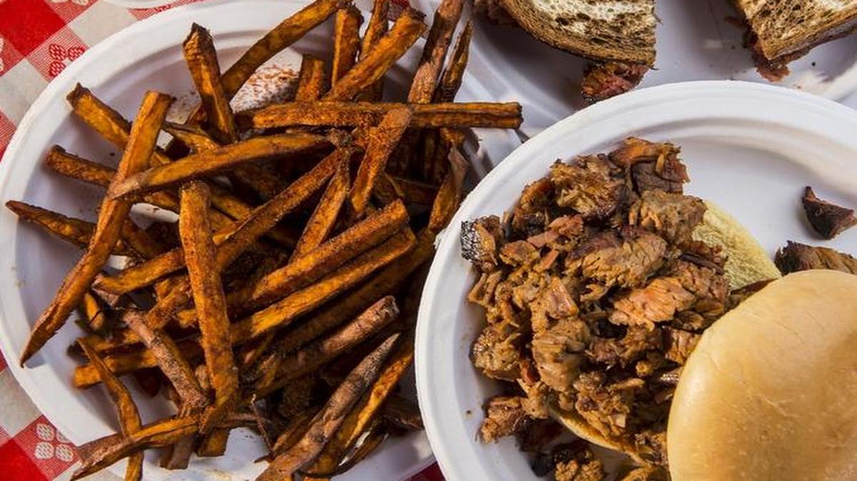 The Ol’ Smoky burnt ends sandwich, lower right, the Big D sandwich, upper right, with sweet potato fries, available at Danny Edward’s BBQ, one of 358 food establishments with top grades for inspections in 2016.