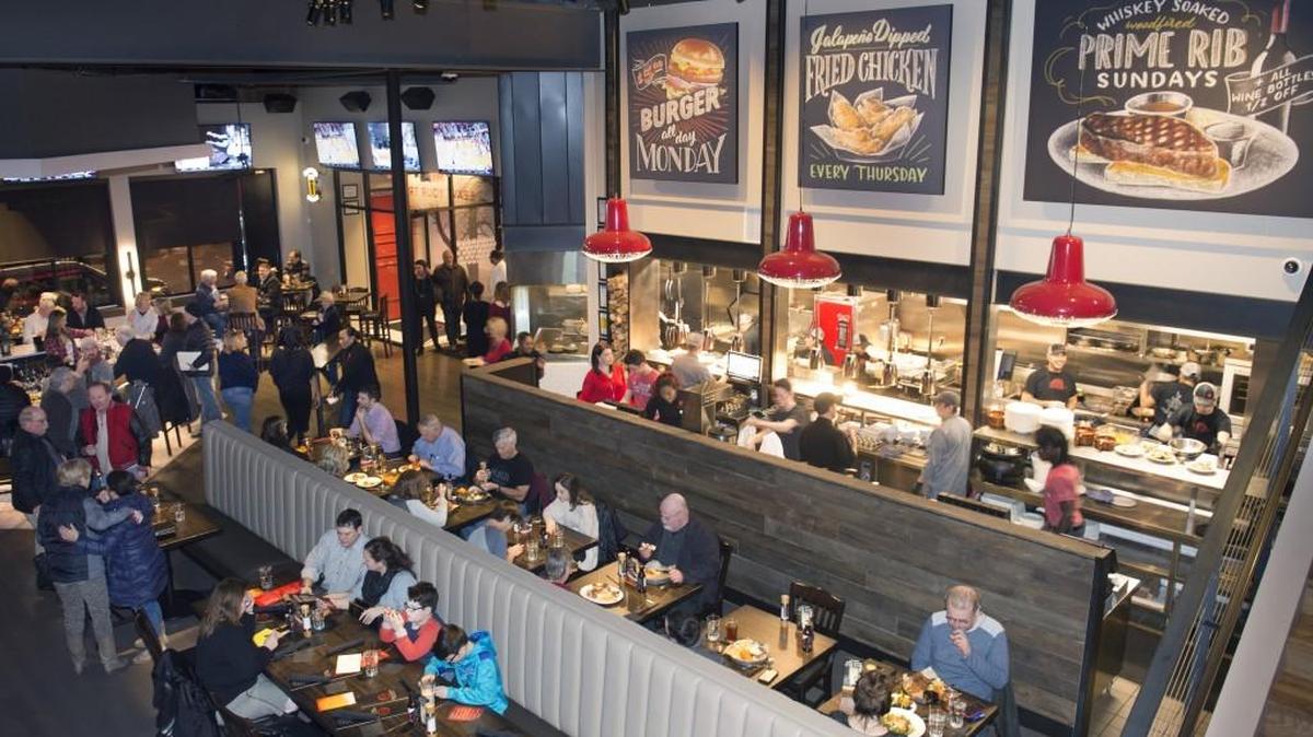 The Brookside restaurant has an industrial decor and open kitchen. Brian Holland of North Kansas City’s B. Holland & Co. built the bar and table tops, benches in the booths, and a firewood cage on the back deck and inside.