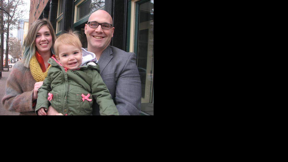 
Erik and Lesley and Erick Borger with their 1-year-old daughter, Emersyn, in the River Market. 
