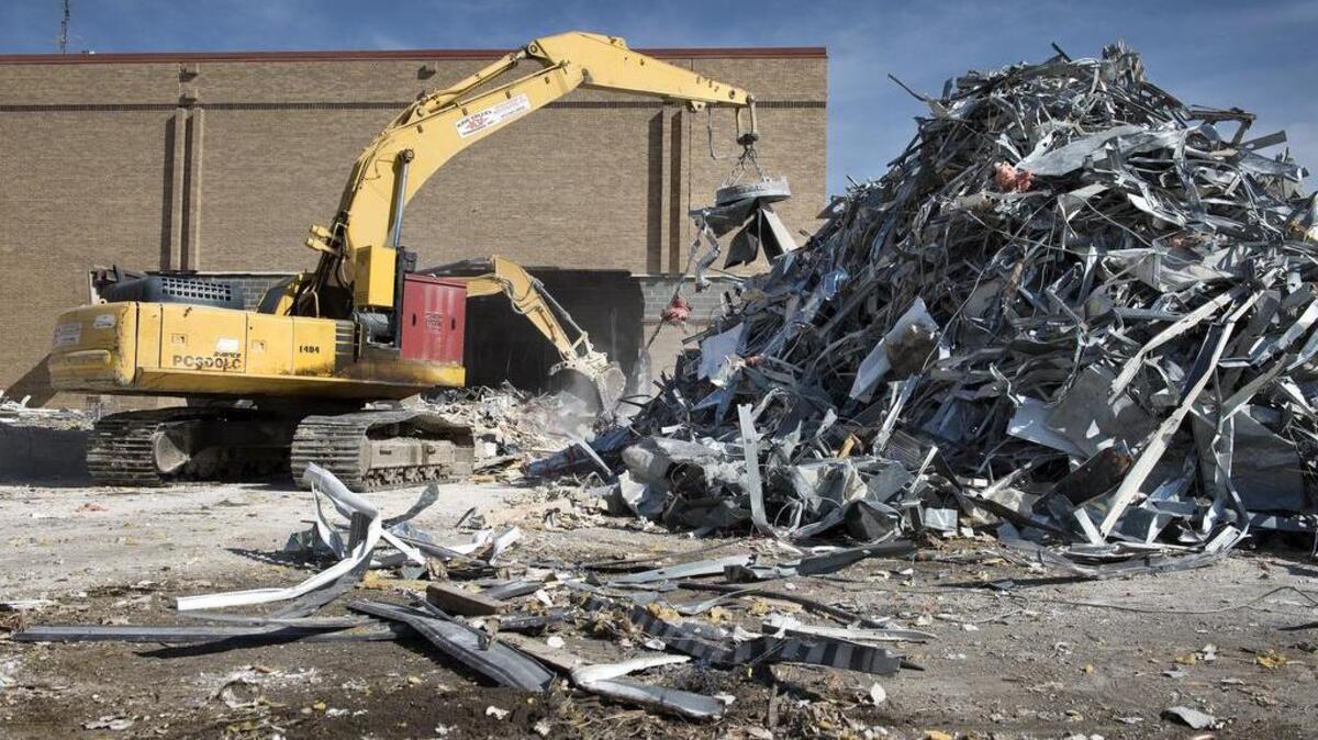 Workers from the Kaw Valley Companies piled up metal for recycling last month at Indian Springs Shopping Center in Kansas City, Kan. They recently began demolition of the 700,000-square-foot enclosed shopping center. It opened in 1971.