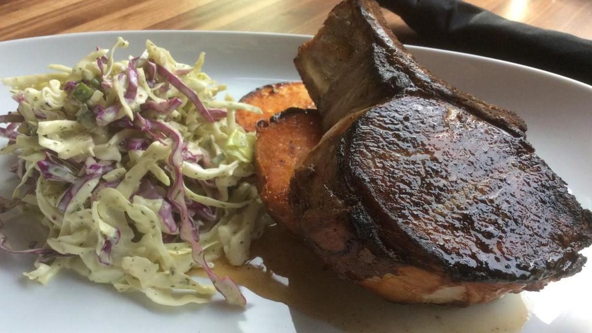 Parkway’s Prairie Farms pork chop is cooked in a wood-fired oven and finished with an apple bourbon glaze. It served with dill coleslaw and roasted sweet potatoes.