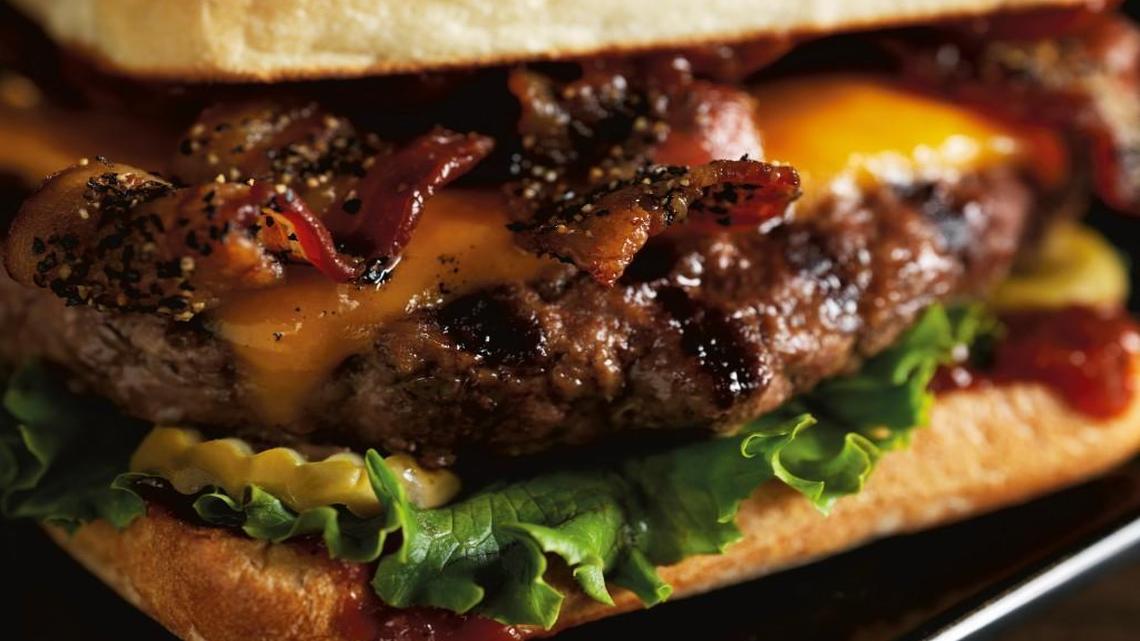 Red Robin’s Smoke & Pepper burger (a half pound of Black Angus topped with black-pepper bacon and extra-sharp cheddar on a toasted ciabatta bun with house-made Smoke & Pepper ketchup).