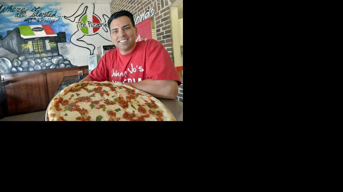 
John Milone Jr. of Johnny Jo’s Pizzeria west of the Plaza has opened the Pizzeria at 516 W. 103rd St. in south Kansas City. He showed off one of his pizza creations in the new location. 


