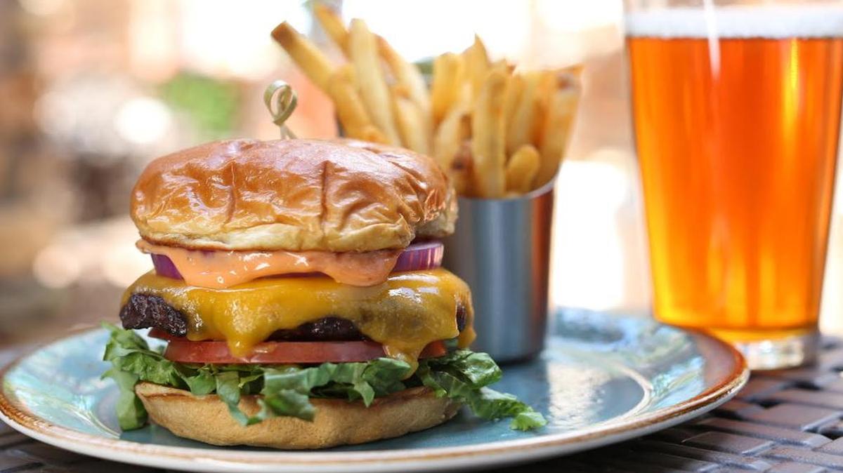 The Famous Pip’s burger with Vermont cheddar, beefsteak tomato, red onion, and house “secret” sauce.