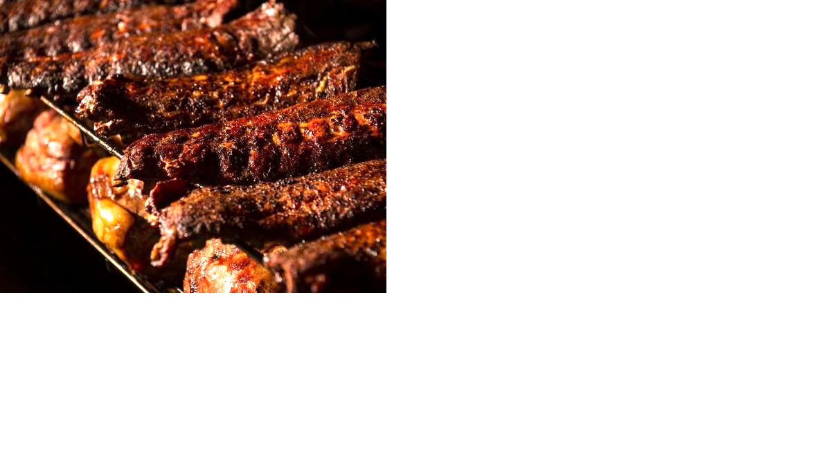 Ribs cook on a smoker carousel at Fiorella’s Freight House location.

