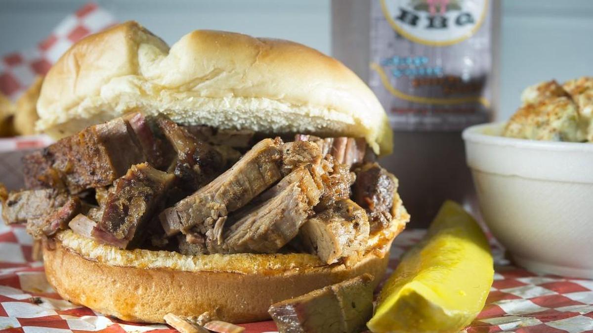 Mudhole BBQ serves a variety of sandwiches, including brisket, and sides such as potato salad.