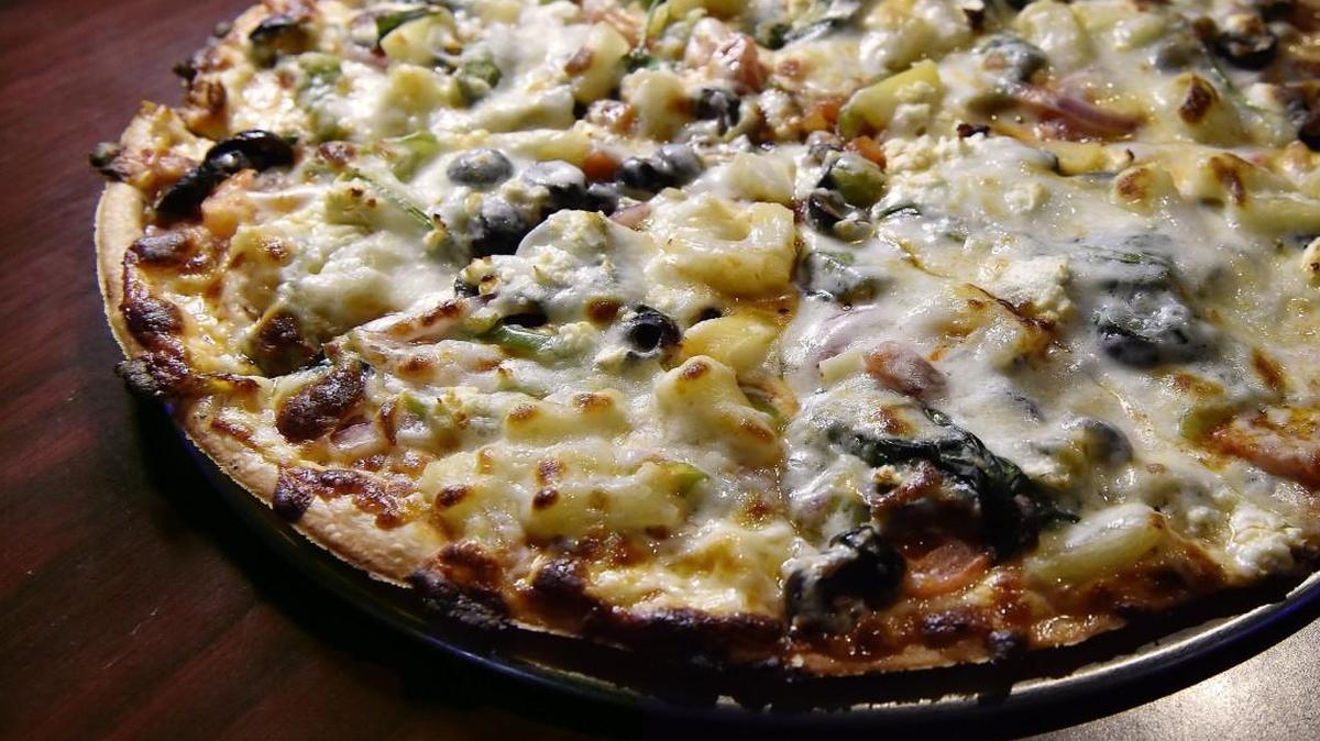 The veggie pizza, with spinach and pineapple, at J&S Pizza in Liberty.