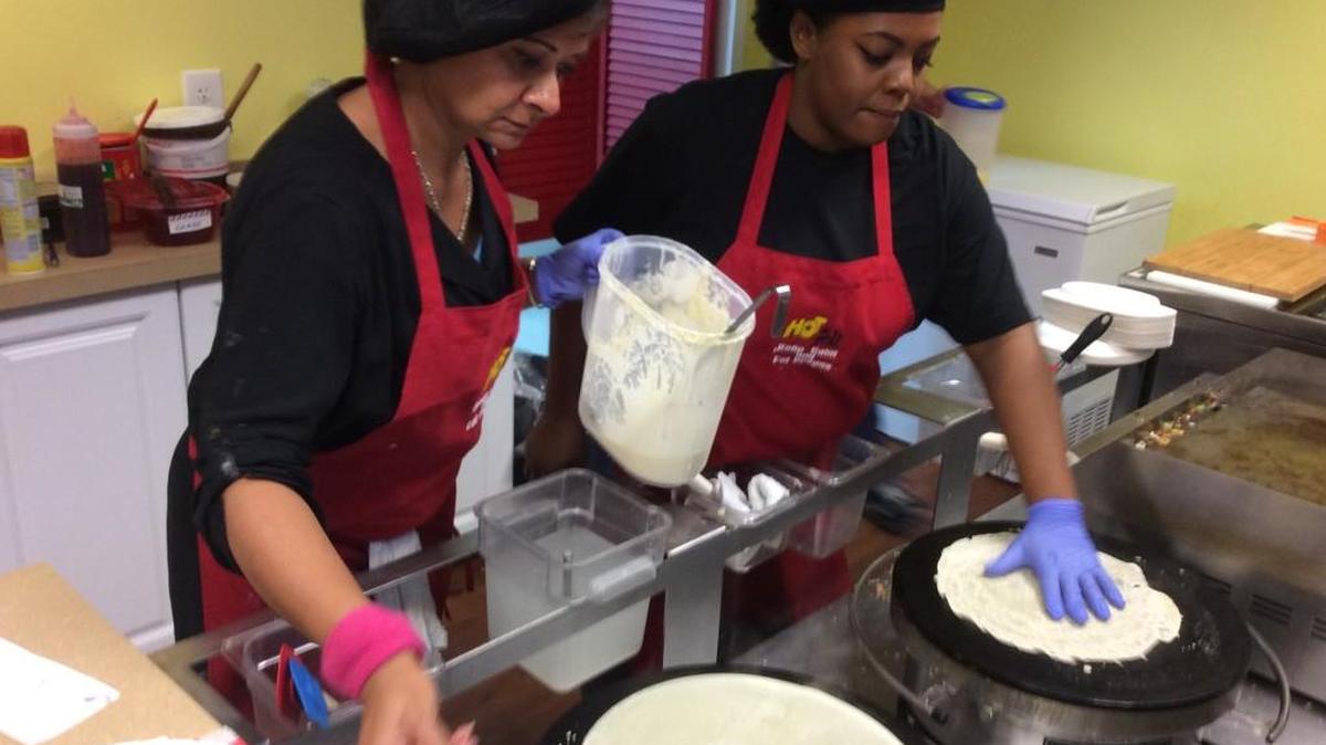 Linda Aziz, left, and Tonisha Bynes in Let’s Crepe’s open kitchen.