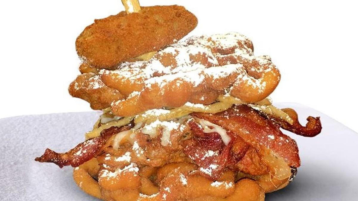 The Pulled Pork Patty Melt is a skewered dish of funnel cake, barbecue pulled pork, fried onion, shredded cheddar and Monterey Jack cheeses, bacon and jalapeno pepper.