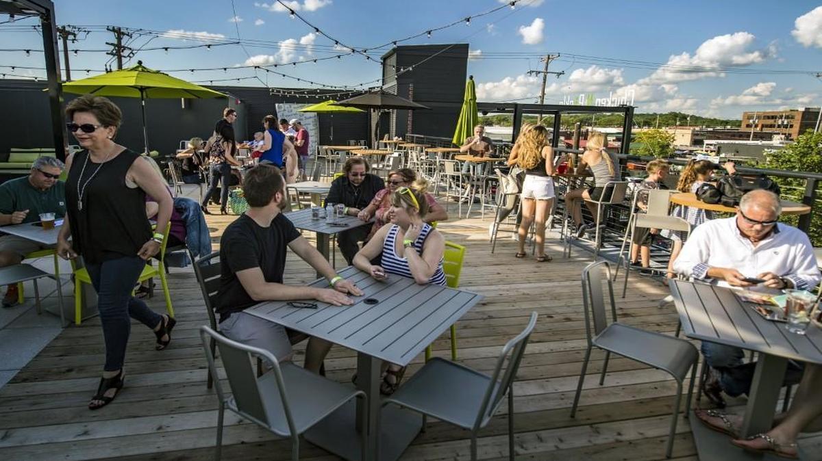 Chicken N Pickle’s rooftop patio is perched above the North Kansas City rotisserie chicken restaurant and overlooks pickleball courts and yard games, a weekend food truck hub and a beer garden with a KC Bier Co. shack.