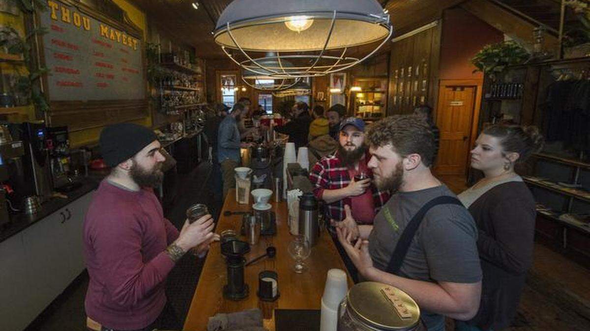 
Thou Mayest Coffee Roasters and Torn Label Brewing Co., neighbors in the east Crossroads district, recently collaborated on Cafe Dubbel, a coffee-flavored beer. Tyler Price (left), a barista at Thou Mayest, talked with Travis Moore, co-owner of Torn Label, last week
