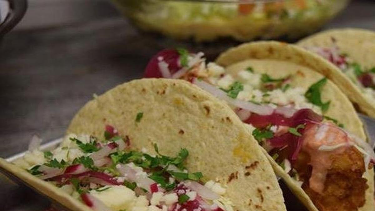 Taco Hangover’s oxtail taco (left), fried shrimp, and pork and pineapple taco (right).
