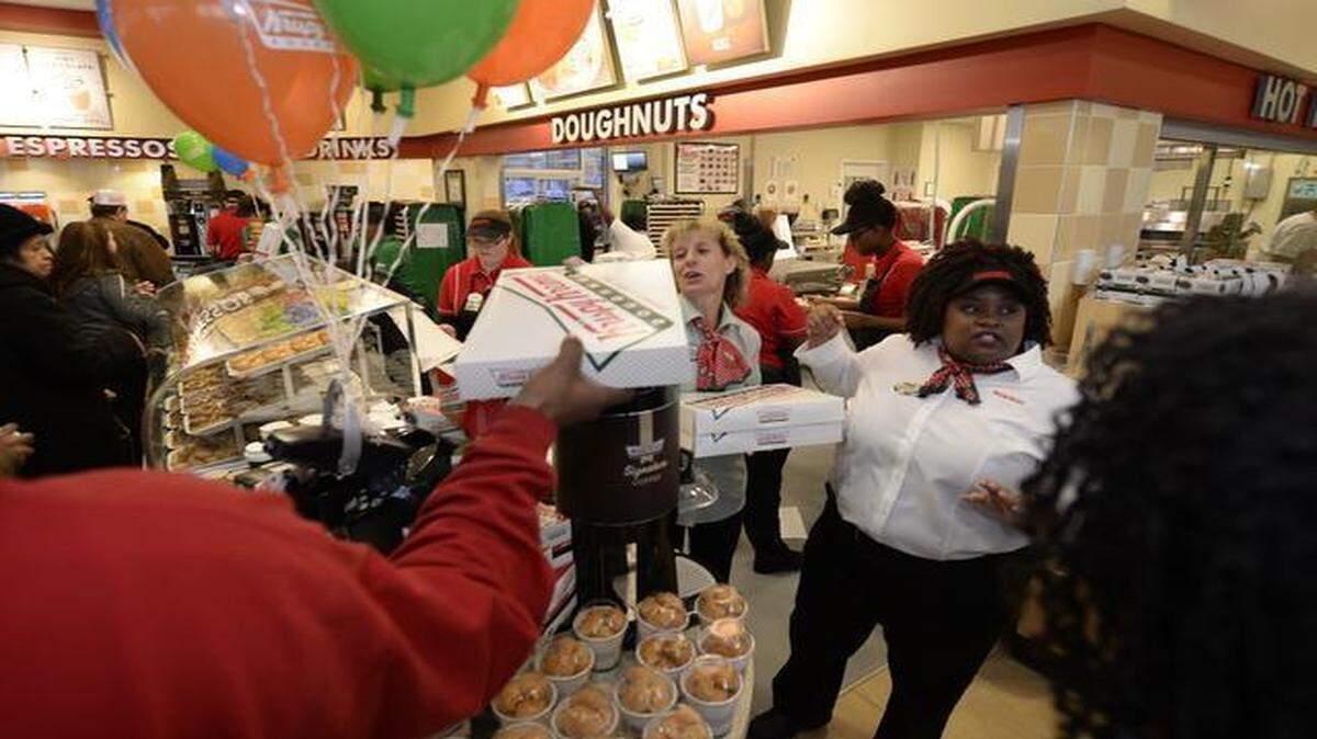 
Doughnut fans waited overnight for the opening of Krispy Kreme’s 1,000th store, at 7648 State Ave. in Kansas City, Kan. The first person in the door got a dozen free donuts a week for a year, and the next 99 got a dozen donuts a month for a year.
