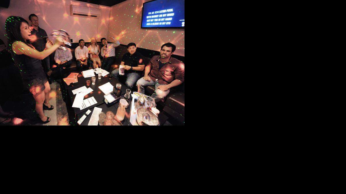 
Customers sing in one of the private lounges at Offkey Karaoke Lounge & Suites, a new business in Westport. Its grand opening was Friday night. Kim Huynh, left, shakes a tambourine with singers (from left) Brett Scherer, Andy Anand, True Seidl, Breanna Iserc, Adil Rehman, Toan Nguyen and Nathan Corn.
