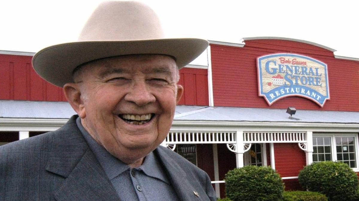 A quest for quality sausage to serve the truckers who filled his 12-stool, 24-hour-a-day steakhouse in southeast Ohio led Bob Evans — pictured in 2003 in front of his restaurant in Rio Grande, Ohio — to create the restaurant chain that bears his name. On Monday, the New Albany, Ohio-based chain announced the closing of 27 restaurants. Evans died in 2007 at age 89.