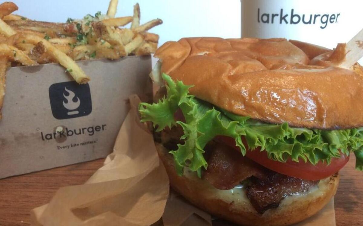 The Larkburger, a black Angus beef burger with lettuce, tomato, onion, pickle and house sauce, cooked to order, and a side of truffle and Parmesan french fries.