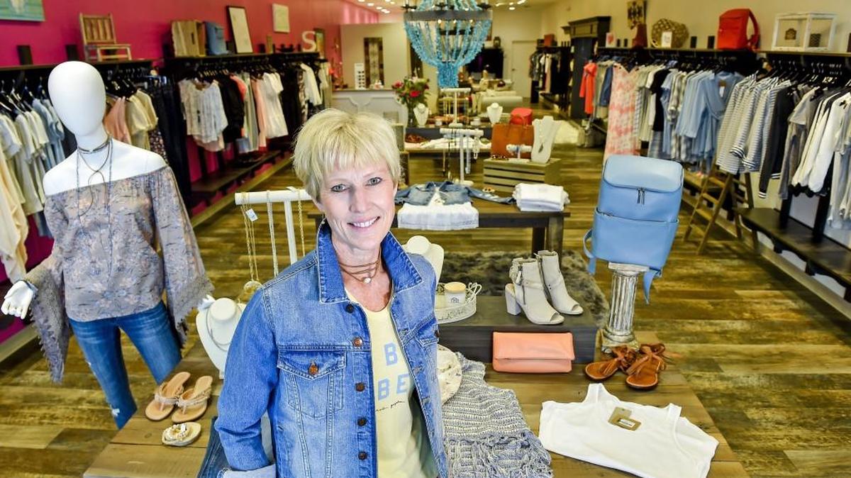 Susan Williams stood in her store Scout & Molly, a franchise national boutique, on Friday, March 24, in Leawood's Town Center Plaza.