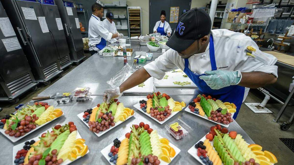 
Jamal Haynes, a prep cook with Aramark at Kauffman Stadium, worked on preparing fruit and cheese trays for the ballpark’s suites before Tuesday’s Royals home game against the Minnesota Twins.

