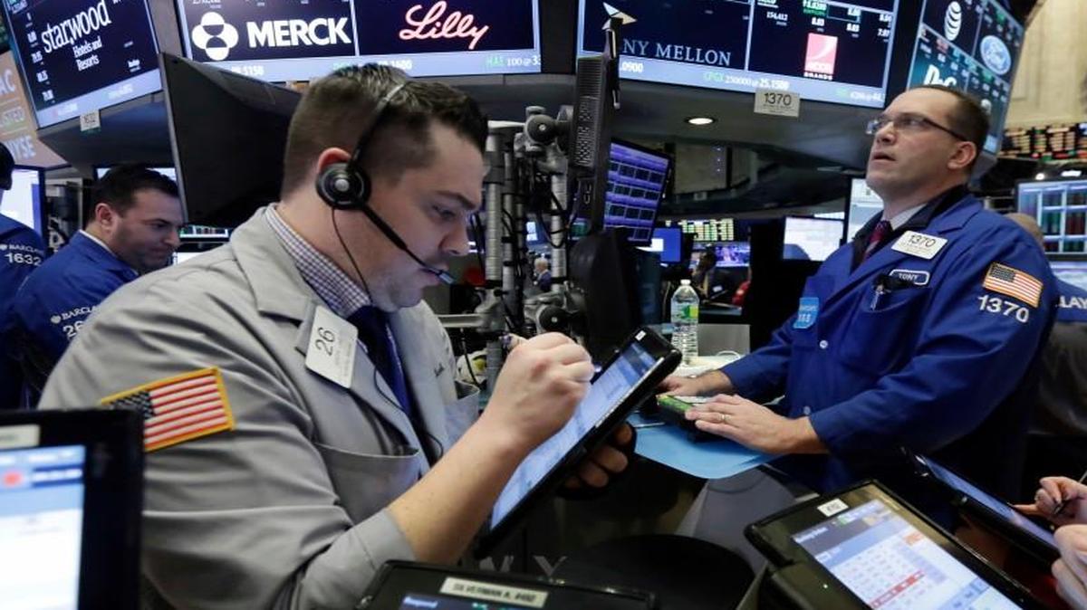 Traders gathered Friday at the post of Anthony Matesic (background right) on the floor of the New York Stock Exchange.