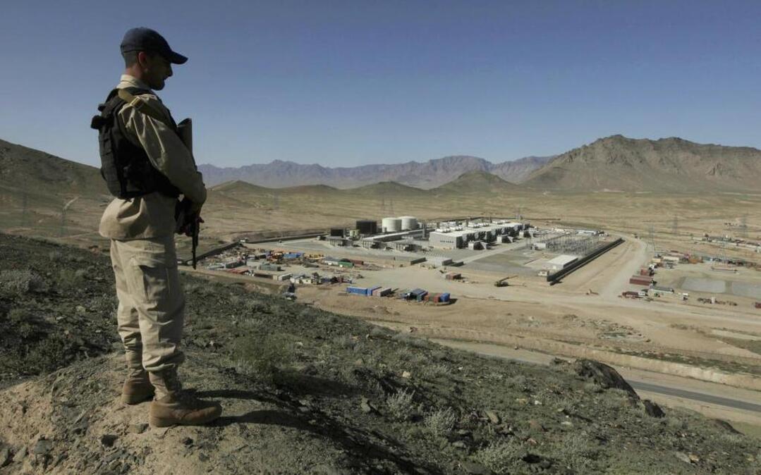 In this May 2010 photo, a guard stands over the Tarakhil power plant in the outskirts of Kabul, Afghanistan. Black & Veatch worked on the project, which is separate from the Kandahar Helmand Power Project.