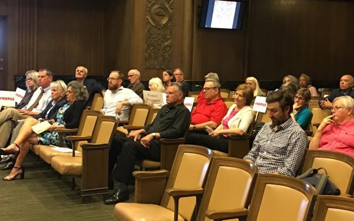 Some Kansas Citians who testified against a proposed apartment complex at Westport Road and Broadway came to the City Plan Commission meeting Tuesday with signs indicating disapproval of the plan.