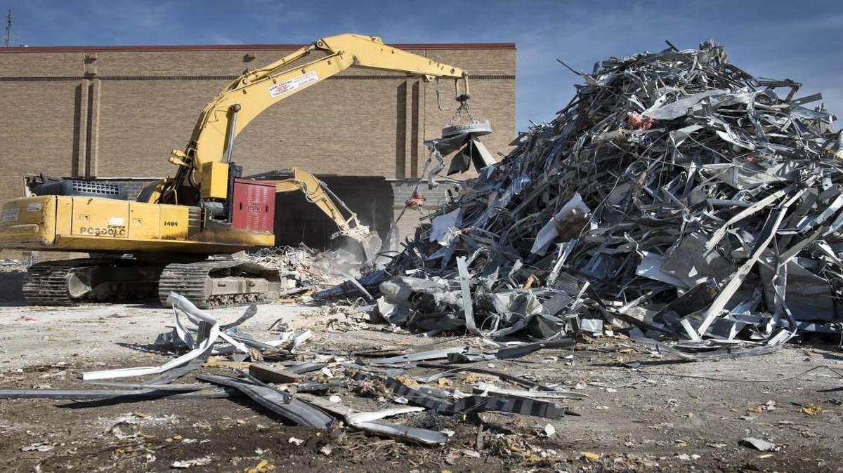 Workers from the Kaw Valley Cos. piled up metal for recycling in 2016 at the defunct Indian Springs Mall site in Kansas City, Kansas. The property, owned by the Unified Government since 2007, has yet to see a revival long desired by local leaders and residents.