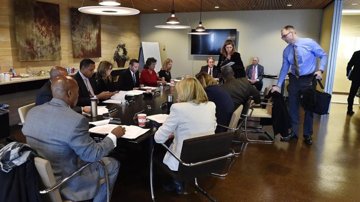 The Kansas City TIF Commission voted Tuesday to approve a development agreement for Shirley Helzberg’s project, a new BNIM headquarters at 1640 Baltimore, during a special meeting at the Economic Development Corporation office, 1100 Walnut. Moments after the vote, three commissioners — Debbie Siragusa (standing, from left), Scott Jacoby and Johnny Sweeney (in door) — walked out. Siragusa said they felt there was no point to staying when they were going to lose the vote.