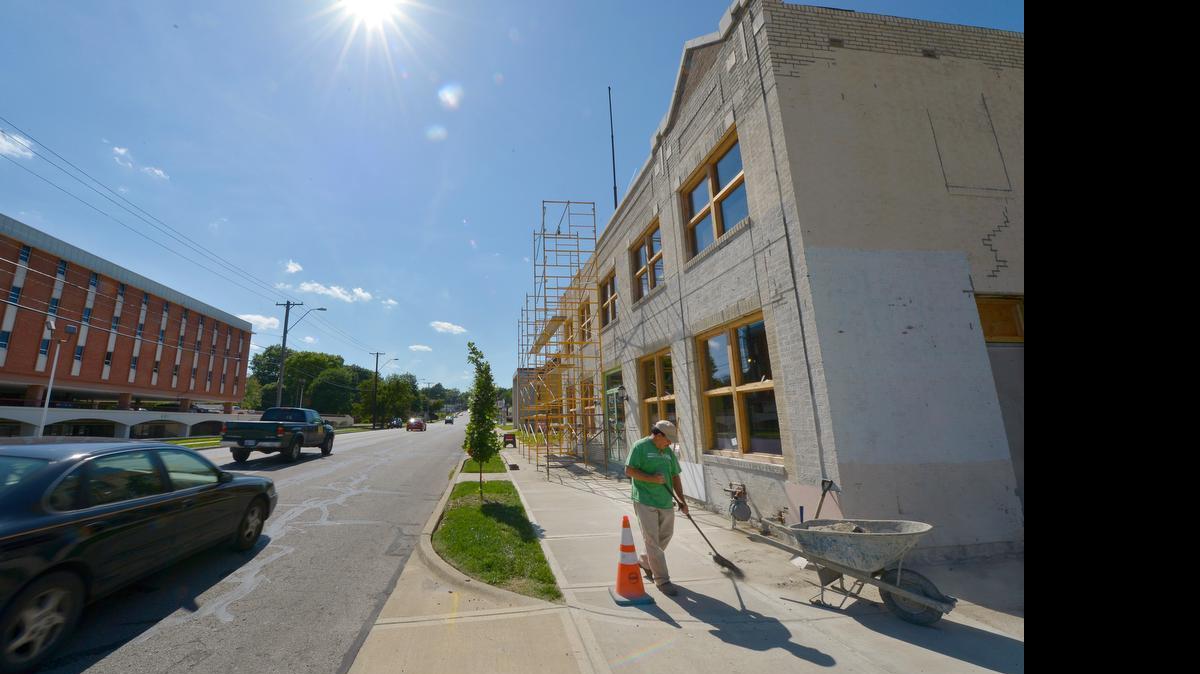 Pascual Carrillo Pizzarro worked last week outside the former Alanz Theater, which is being transformed into the Brookside Gardens Event Center. Several projects along 63rd Street between Oak and Holmes.