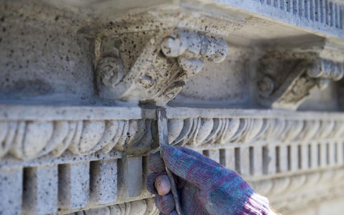 
Mike Merola, lead plasterer for Plasterkraft & Mural Masters, restored some of the detailing on a section of plaster at the Gumbel Building, 801 Walnut St. 
