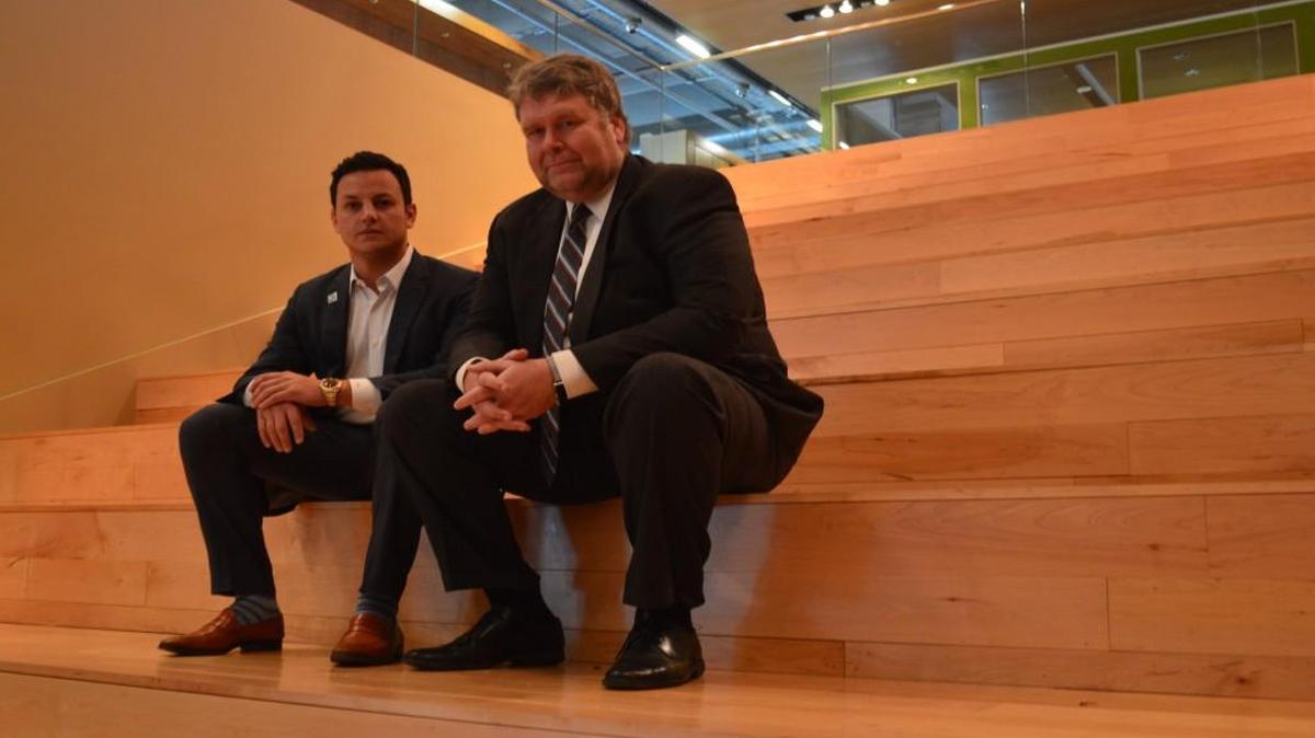 Ian Ross of Somera Road (left) worked with Kansas City Manager Troy Schulte and the owners of River Market West to find a solution to the parking problem. A previous arrangement curtailed the number of parking spaces that could be offered to office tenants.