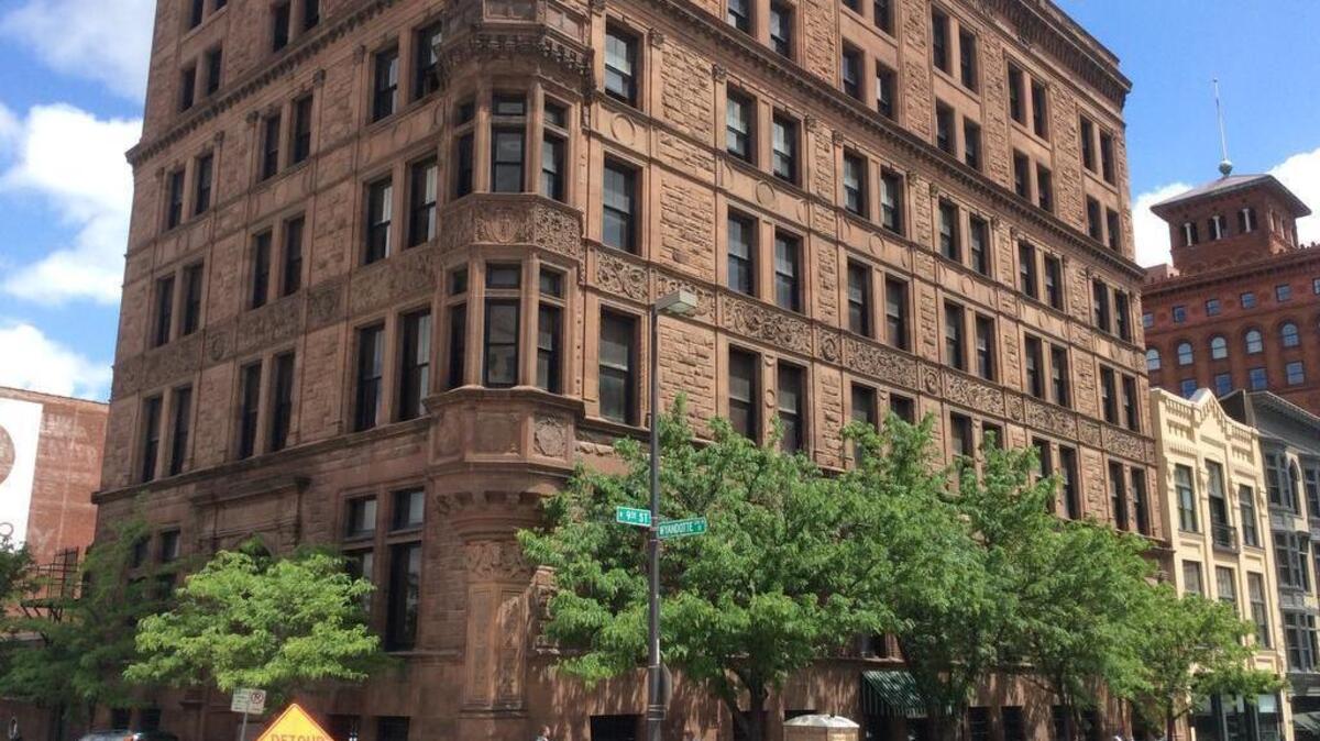 The New England Life building at 112-120 W. Ninth St. was constructed in 1886 and 1887. The seven-story, red brick building is slated to become 32 market-rate apartments.