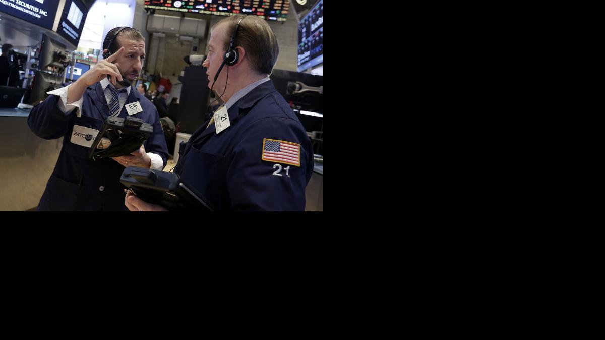 
Traders Greg Mulligan, left, John Doherty work on the floor of the New York Stock Exchange Wednesday
