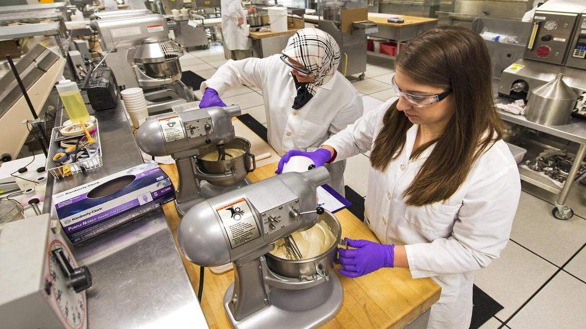 
Food scientists Narges Farvili (left) and Gina Norman added water to cake batter before testing the batter’s viscosity at the innovation center at 7905 Quivira Road in Lenexa. Corbion makes and tests ingredients for the food industry.
