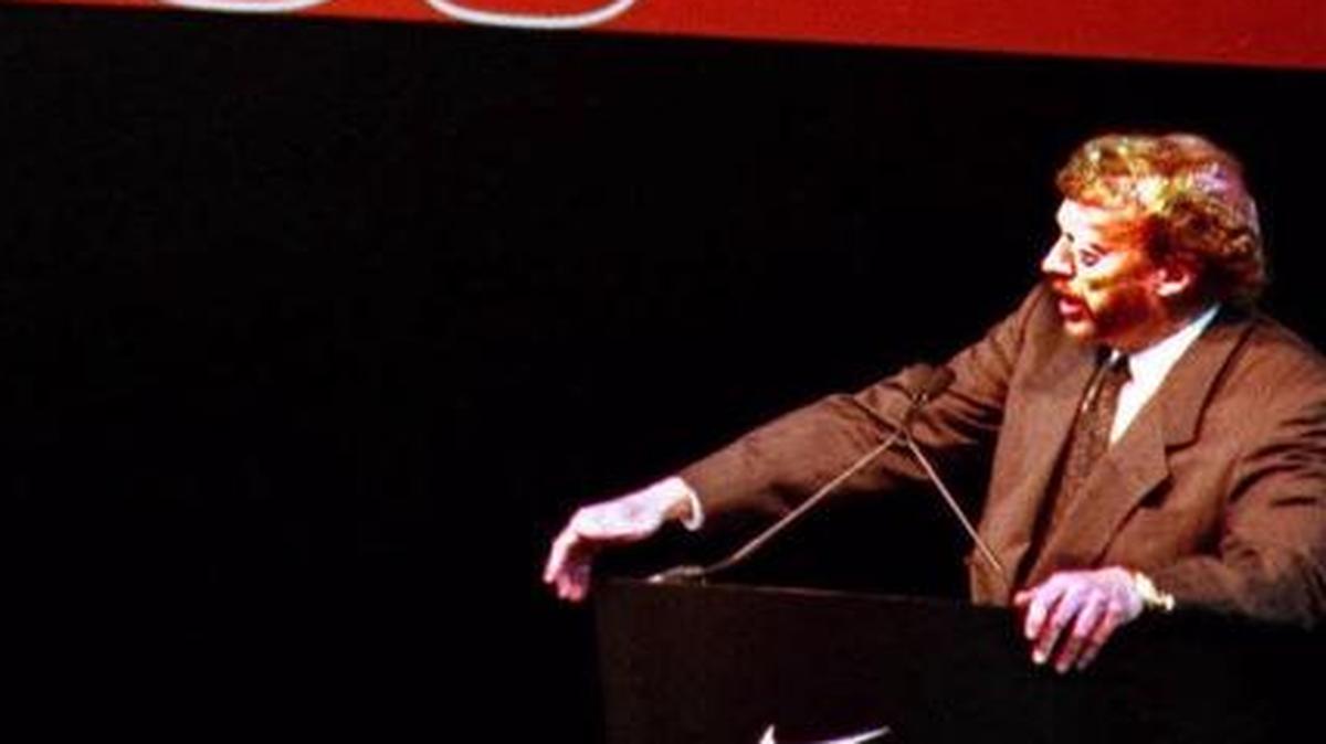 
Nike Chairman Phil Knight appears under a gigantic swoosh during the company's annual shareholders meeting in Beaverton, Ore. Knight announced on Tuesday plans to step down from the position next year.
