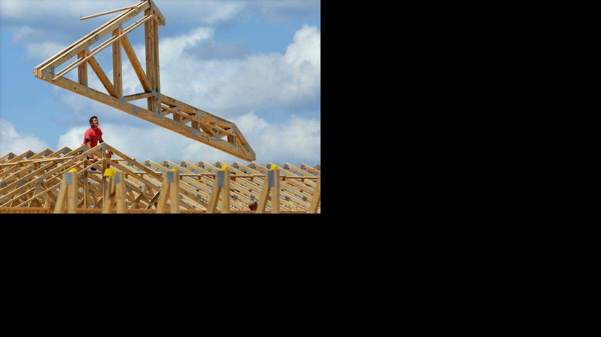 Earlier this month, construction workers built a commercial complex in Springfield, Ill. The government Wednesday issued its first of three estimates of how fast the U.S. economy grew in the April-June quarter.