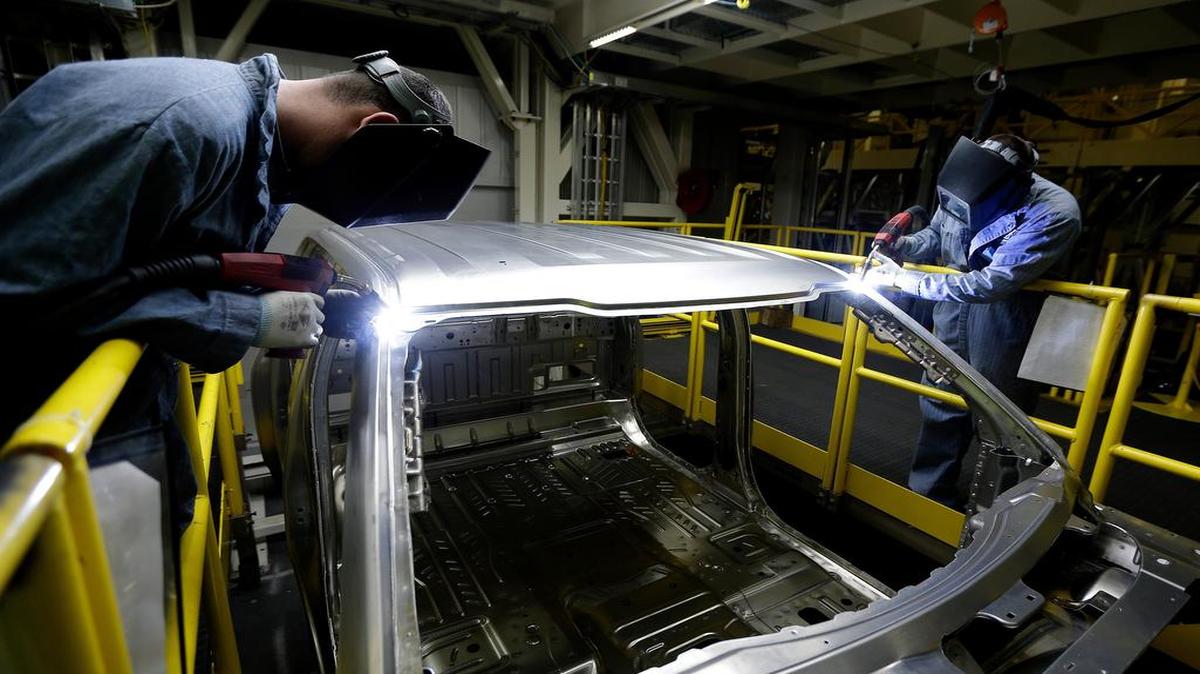 
Workers weld body panels on the Ford F-150 truck at the Ford Claycomo plant.
