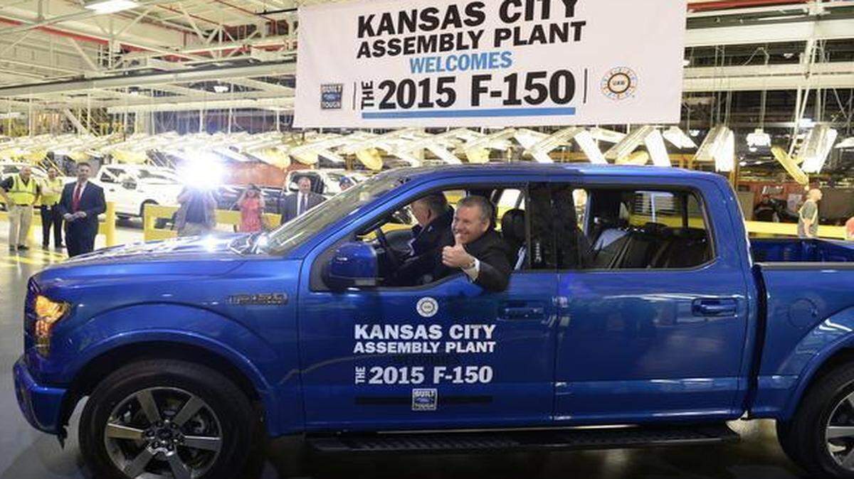 
Joe Hinrichs, Ford’s president of the Americas, gives a thumbs up as he drives the first new F-150 to roll off the line at the Ford Claycomo plant Friday morning. Ford officially began producing the new, aluminum-bodied F-150 pickup truck Friday morning, where production line workers were joined by the governor and other dignitaries. 
