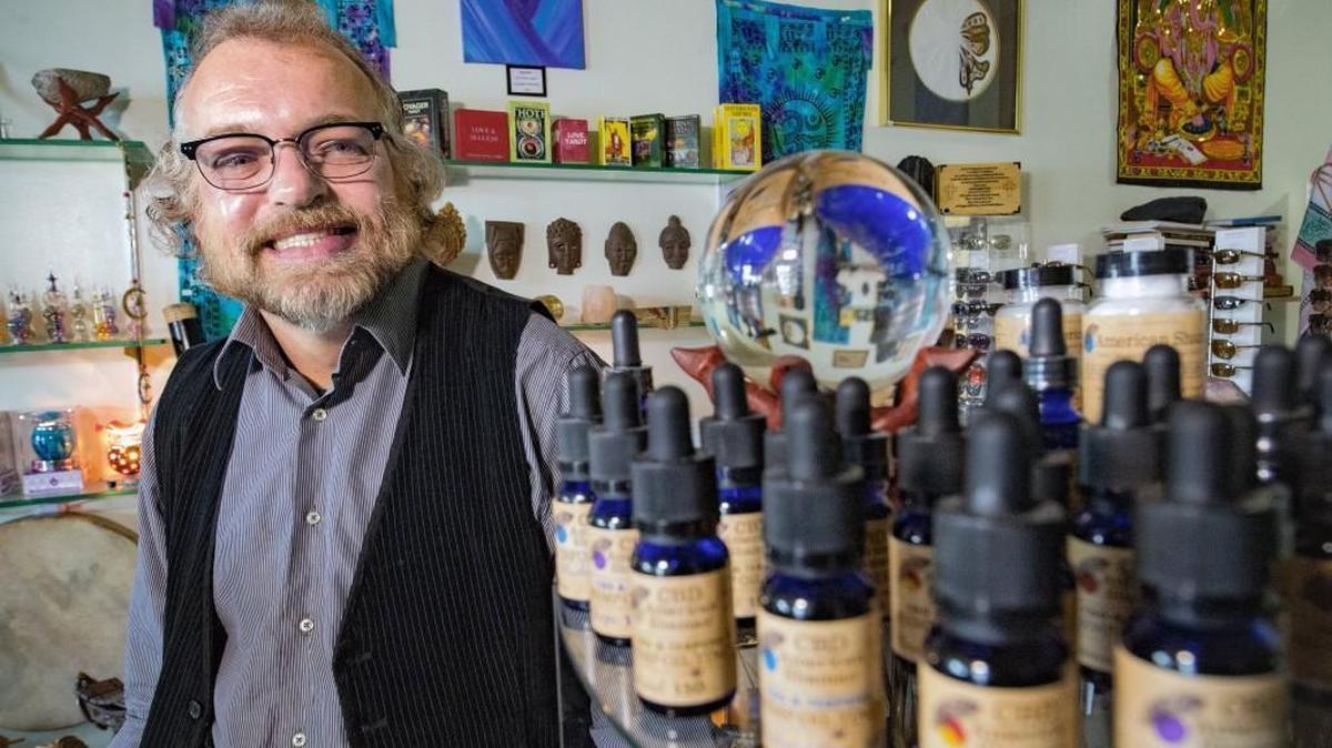 Eddie Smith looked at bottles of hemp oil, or CBD, in his shop Into The Mystic in Mission. His shop, at 5727 Johnson Drive, sells CBD products even though he’s not sure if it’s legal to sell.
