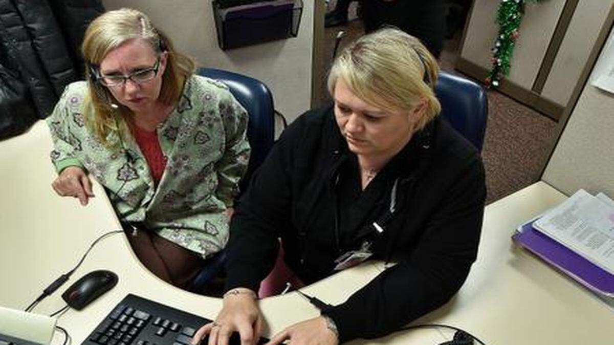 
The call center at Children’s Mercy Hospital was busy Tuesday. Registered nurses Carol Lynn Genilo (left) and Rolanda Peterson responded to a phone call.
